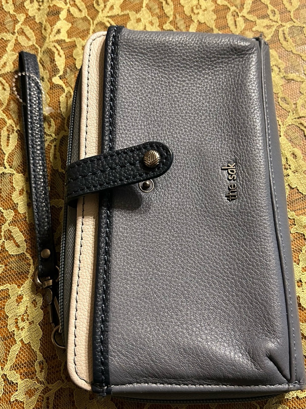The Sak Gray and Cream Leather Wristlet with Black Trim